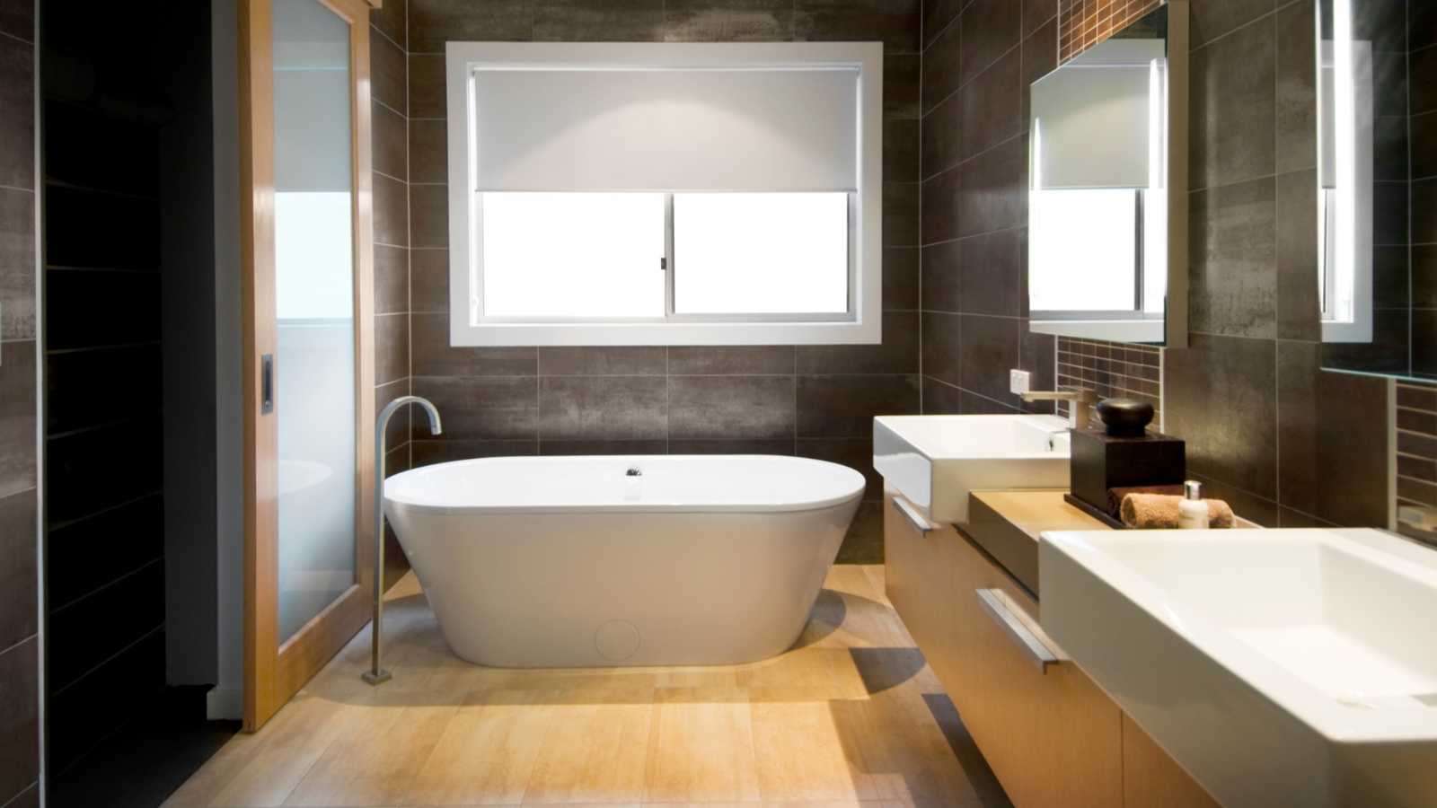 Dark bathroom with freestanding tub
