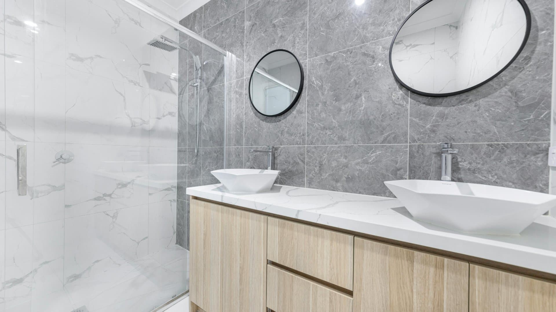 Modern powder room with double vessel sink and grey marble
