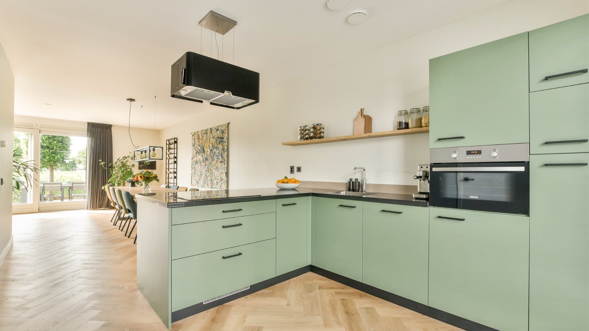 Modern kitchen with sage green cabinets and contemporary finishes